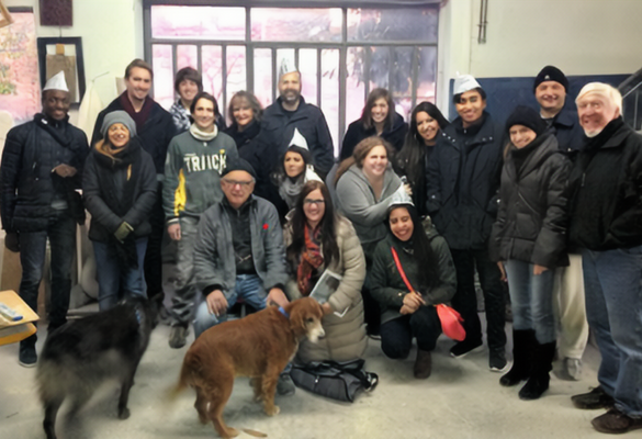 A group of people and two dogs posing for a photo